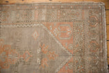 Distressed vintage Oushak runner texture in peach apricot and grey, with geometric border.