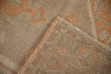 Distressed Oushak rug runner's edge, revealing low pile and hand-knotted reverse.