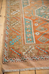 Vintage distressed Melas rug, madder root rust and sky blue serrated leaf borders.