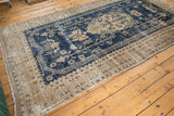 Fantastic contrast and distressed texture of the Oushak rug's navy and antique ivory patterns.