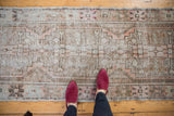 Distressed vintage Oushak runner showcasing faded geometric pattern, muted ivory, silver, and mauve blush.