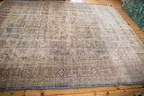 Textured vintage Distressed Oushak rug surface with faded denim blue and pale rust.