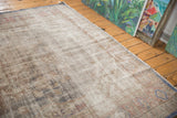 Distressed Oushak carpet showing surface wear to knot heads and muted tones.