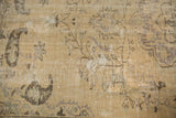Distressed Oushak rug pile shows even wear, subtle vinery motifs, and visible foundation.
