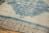 Distressed Oushak rug: worn denim blue design, ivory field, and detailed beige border.