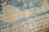 Detail of distressed Oushak rug showing worn blue serrated pattern and low pile.