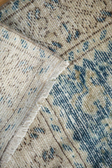 Distressed Oushak rug pile with ivory and blue tones, showing texture and reverse.