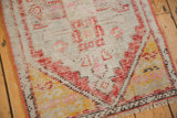Vintage Distressed Oushak corner, showing low pile, brick rust, saffron serpent-filled spandrels.