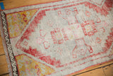 Distressed texture and secured perimeter of a vintage Oushak rug corner.