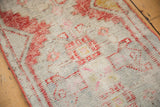 Even wear across distressed Oushak runner pile, with faded brick rust and blush rose.