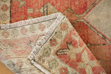 Hand-knotted vintage distressed Oushak rug corner, showing fringe, even pile wear, and foundation.