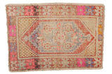 Distressed Oushak rug, geometric lozenge medallion in softened red, blush pink, and pale gold.