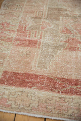 Distressed Oushak runner pile, with faded chestnut, ivory geometric motifs and secured edge.
