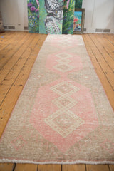 Distressed geometric medallion pattern on a vintage Sparta runner in rose blush and beige.