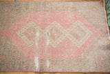 Distressed surface detail of hand-knotted Turkish Sparta runner in rose blush and antique ivory.