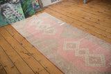 Distressed vintage Sparta rug texture with rose blush, ivory, and beige geometric motifs.