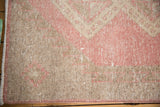 Distressed vintage Sparta rug runner showcasing faded bubble gum rose and ivory tones.