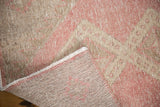 Distressed vintage Sparta rug runner corner, showing faded rose blush pile and hand-knotted foundation.
