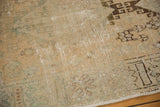 Close-up showing worn pile, visible foundation, and muted geometric patterns on distressed Oushak.