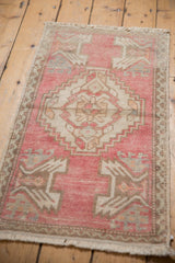 Original side selvage and distressed texture on pink and ivory Oushak rug corner.