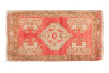 Vintage Distressed Oushak rug mat featuring blush, ivory, and bronze medallion and plant motifs, 1'6