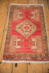 Blush field and germinating plant motif at the end of a distressed Oushak rug.