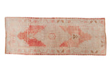 Vintage Distressed Oushak runner with faded blush medallion, ivory field, and meandering vine borders, 3'5