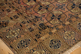 Vintage Turkmen carpet corner with chestnut brown field, navy Bokhara guls, and unique plant borders.