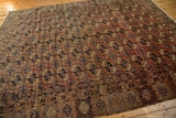 Vintage Turkmen Bokhara carpet with chestnut, navy, and ivory guls and plant border.