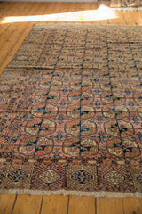 Vintage Turkmen carpet showcasing its unique pomegranate end border, chestnut, navy, and ivory Bokhara guls.