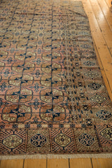 Vintage Turkmen rug end border with simplified pomegranate motifs, navy, ivory, and fringe.