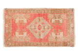 Distressed Oushak rug mat with a blush pink and antique ivory central medallion, 1'6