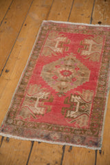 Serrated medallion with pale bronze and antique ivory on a distressed blush Oushak rug.