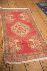 Distressed vintage Oushak rug with low pile texture, showing faded blush, ivory, and bronze.