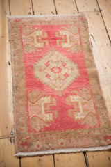 Distressed vintage Oushak rug showing blush, ivory serrated medallion and original side selvage.