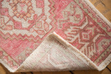 Hand-knotted foundation and distressed pale blush pink Oushak rug pattern, with intact selvage.