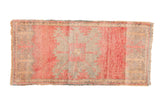 Distressed vintage Oushak rug runner, featuring faded pink medallion and muted silver field.