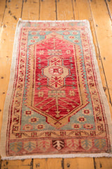 Vintage Oushak runner's corner, showing cherry red, aqua, and rams horn side border.