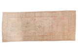 Vintage Distressed Oushak rug runner with single column floral medallions, faded blush, rose, and ivory colors.