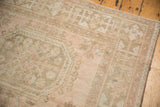Distressed Oushak runner showcasing subtle Kufic border and floral gul motifs in blush tones.