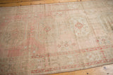 Distressed vintage Oushak runner, blush, rose, and ivory tones, with faint foundation.