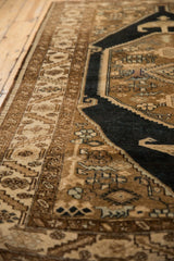 Vintage Northwest Persian rug's distressed low pile, showing rams horn and serrated leaf motifs.
