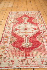 Distressed cherry red field with serrated stepped medallion and antique ivory ground.