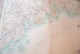 Antique map detail of New Rochelle's grid, parks, and coastal features.