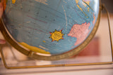 1960s Scholastic globe with 12-inch label, showing the brass axis base and Australia.