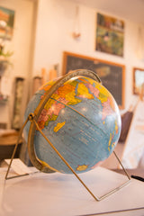 Vintage blue scholastic globe with brass axis and desirable stand base.