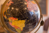 North Atlantic and colorful continents on the aged surface of a vintage black globe.