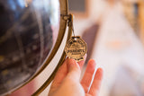 Scalloped Parents Magazine tag detail tied to the vintage Cram's black globe meridian.