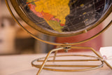Mid-century Cram's black globe with an unusual MCM brass base and paper imperfections.