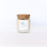 Merry + Bright Slow North Soy Candle, creamy wax in glass jar with cork lid.